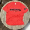 A red shirt that is sitting on top of a table.
