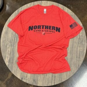 A red shirt that is sitting on top of a table.