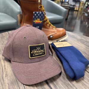 A hat, boots and socks are on the table.