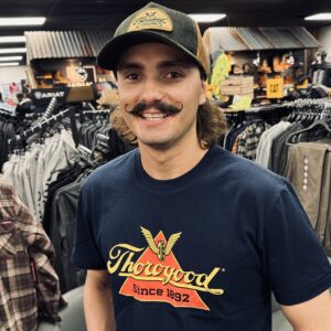 A man with a mustache wearing a hat