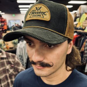 A man with long hair and mustache wearing a hat.