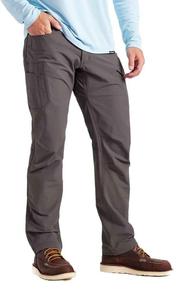 A man wearing grey pants and black shoes.