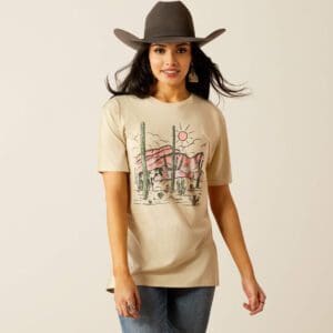 A woman wearing a cowboy hat and jeans.