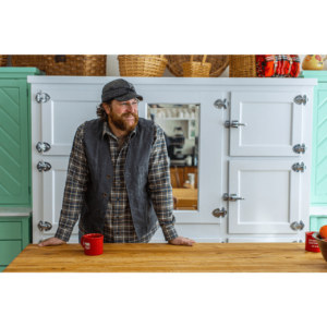 A man standing at the counter of his kitchen.