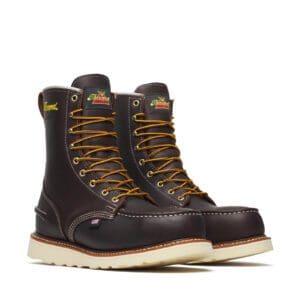 A pair of brown work boots with yellow laces.