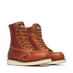 A pair of work boots on top of a white ground.