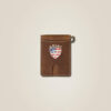 A brown leather wallet with an american flag on the front.