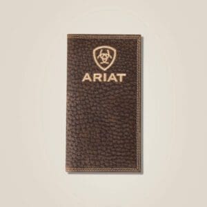 A brown leather ariat wallet sitting on top of a wall.