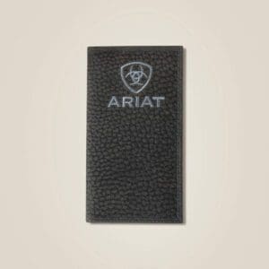 A black ariat wallet sitting on top of a white wall.