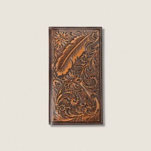 A brown leather book cover with a feather and floral design.