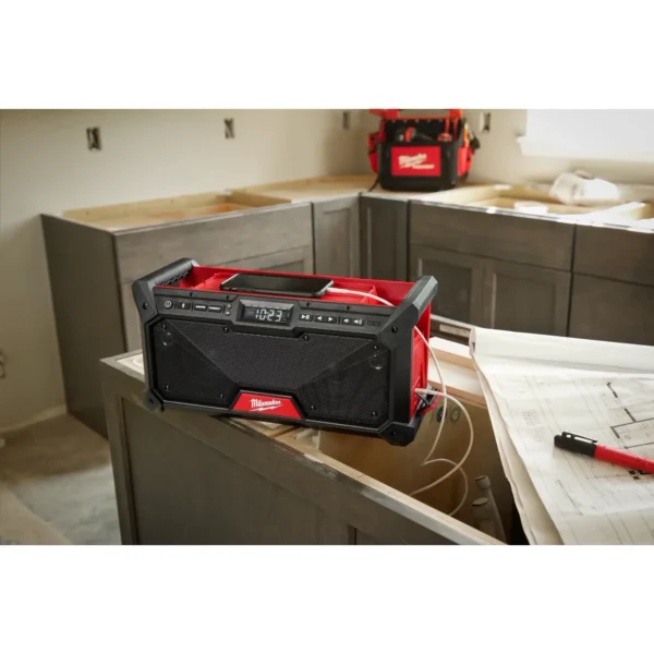 A red and black speaker sitting on top of a counter.