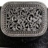 A belt buckle with a decorative design on it.