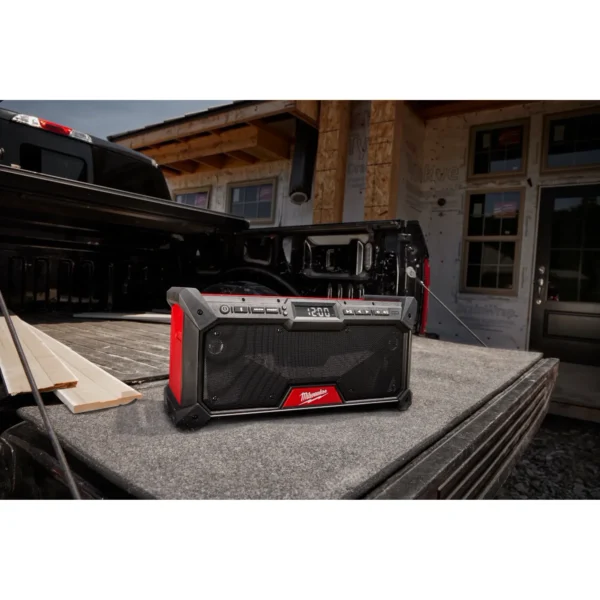 A red and black speaker sitting on top of a table.