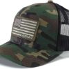 A camouflage hat with an american flag patch on it.