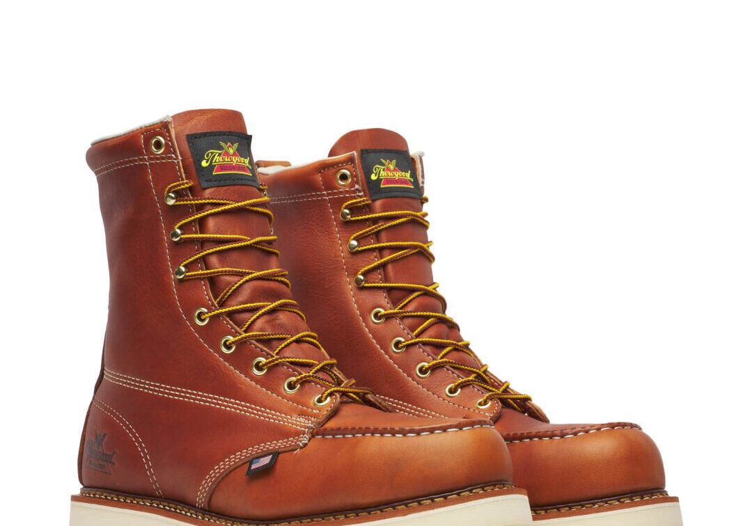 A pair of work boots on top of a white ground.