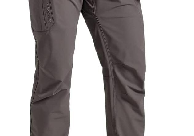 A man wearing grey pants and black shoes.